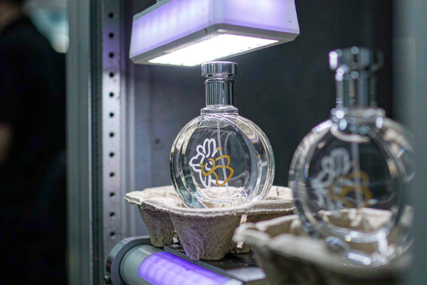 UV cured ink perfume bottle printing under LED curing lamp on a glass decoration line